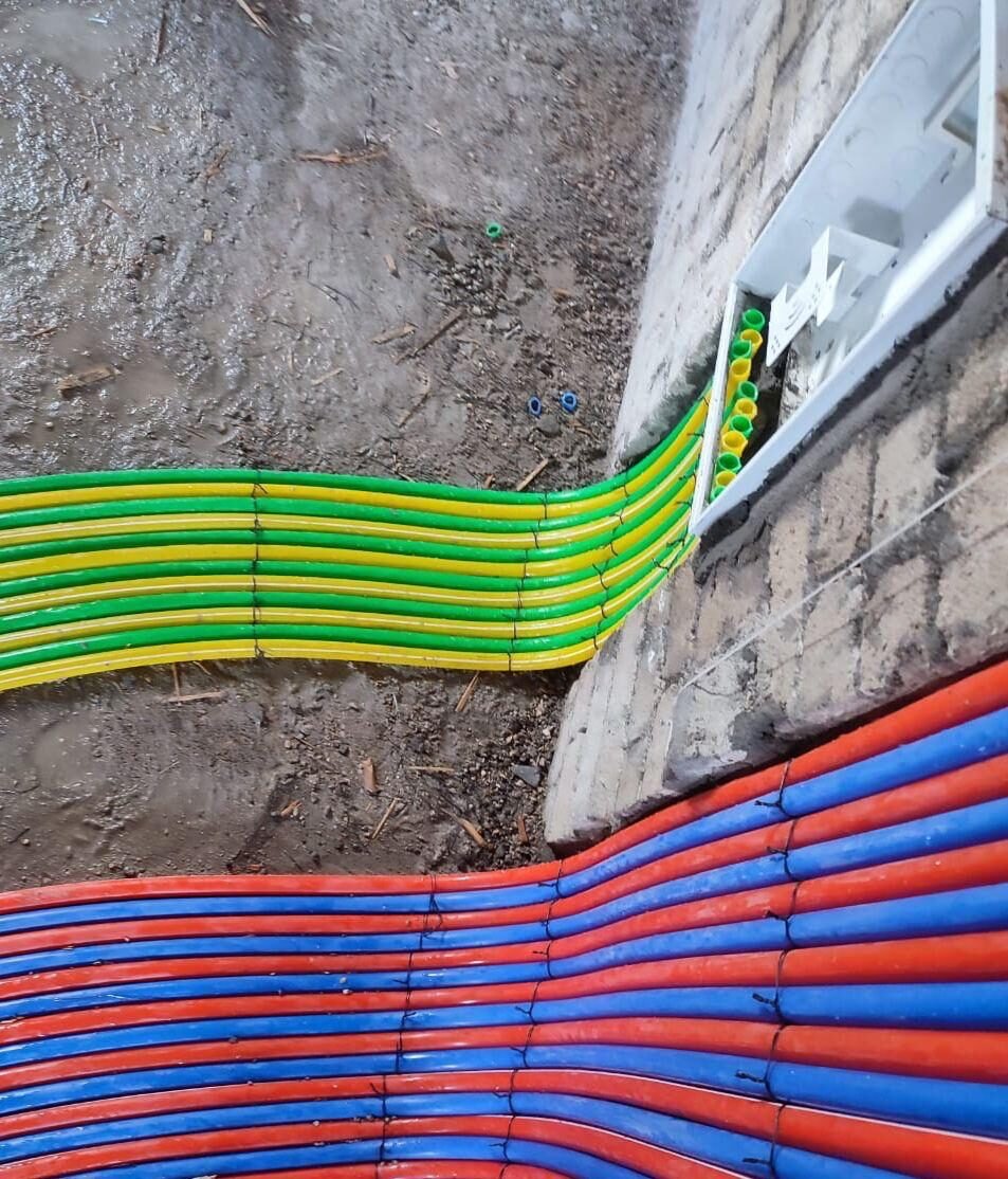 Colour-coded conduit running into a wall box