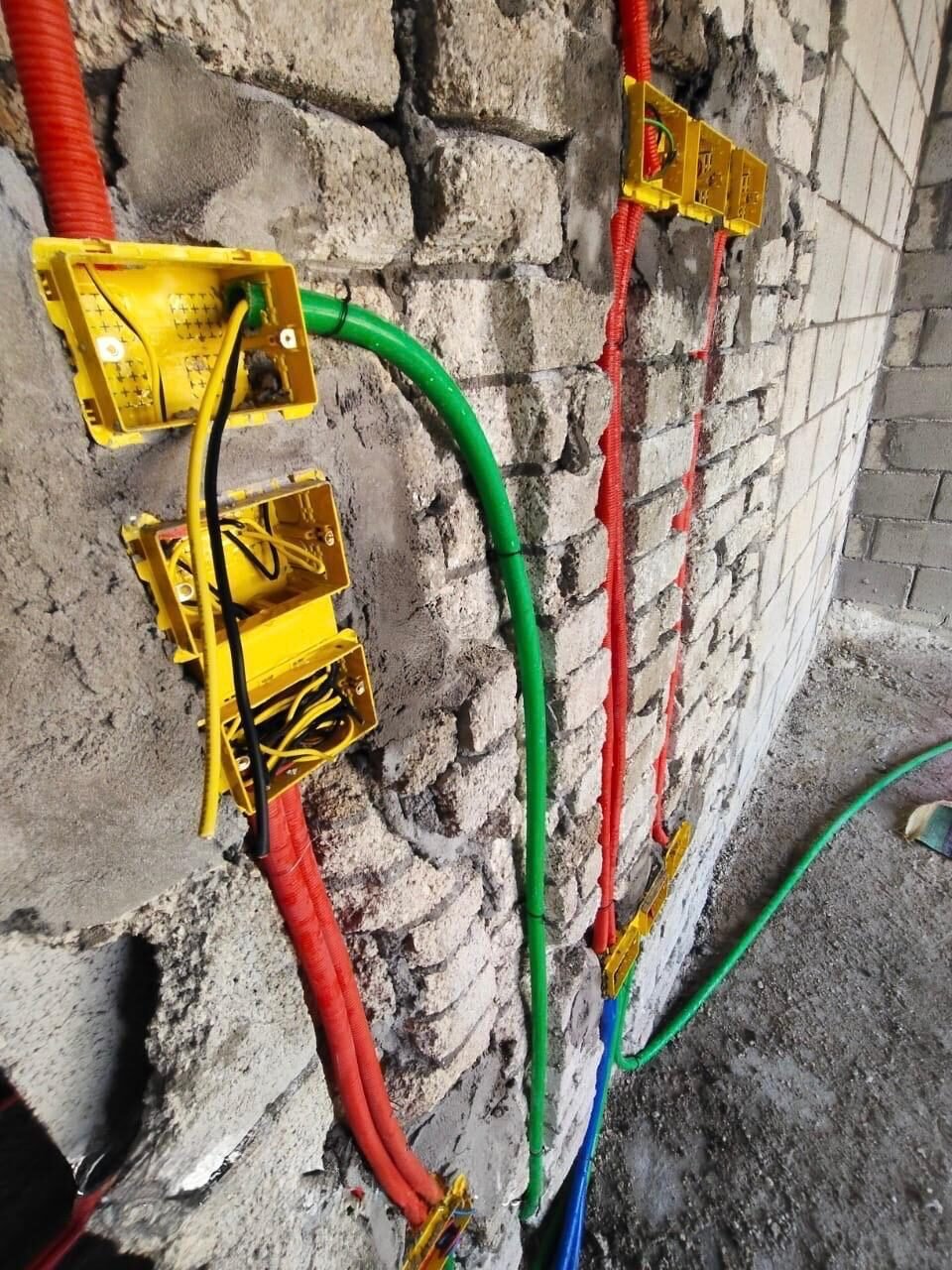 Yellow wall boxes fixed in the blockwork